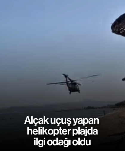 Alçak uçuş yapan helikopter plajda ilgi odağı oldu