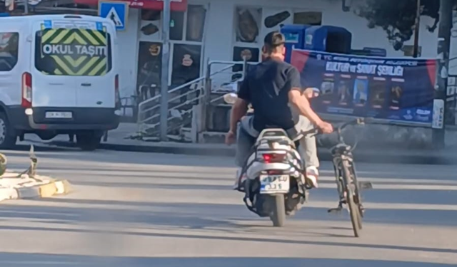 Karacasu'da tehlikeli yolculuk: Motosikletle bisiklet sürdüler