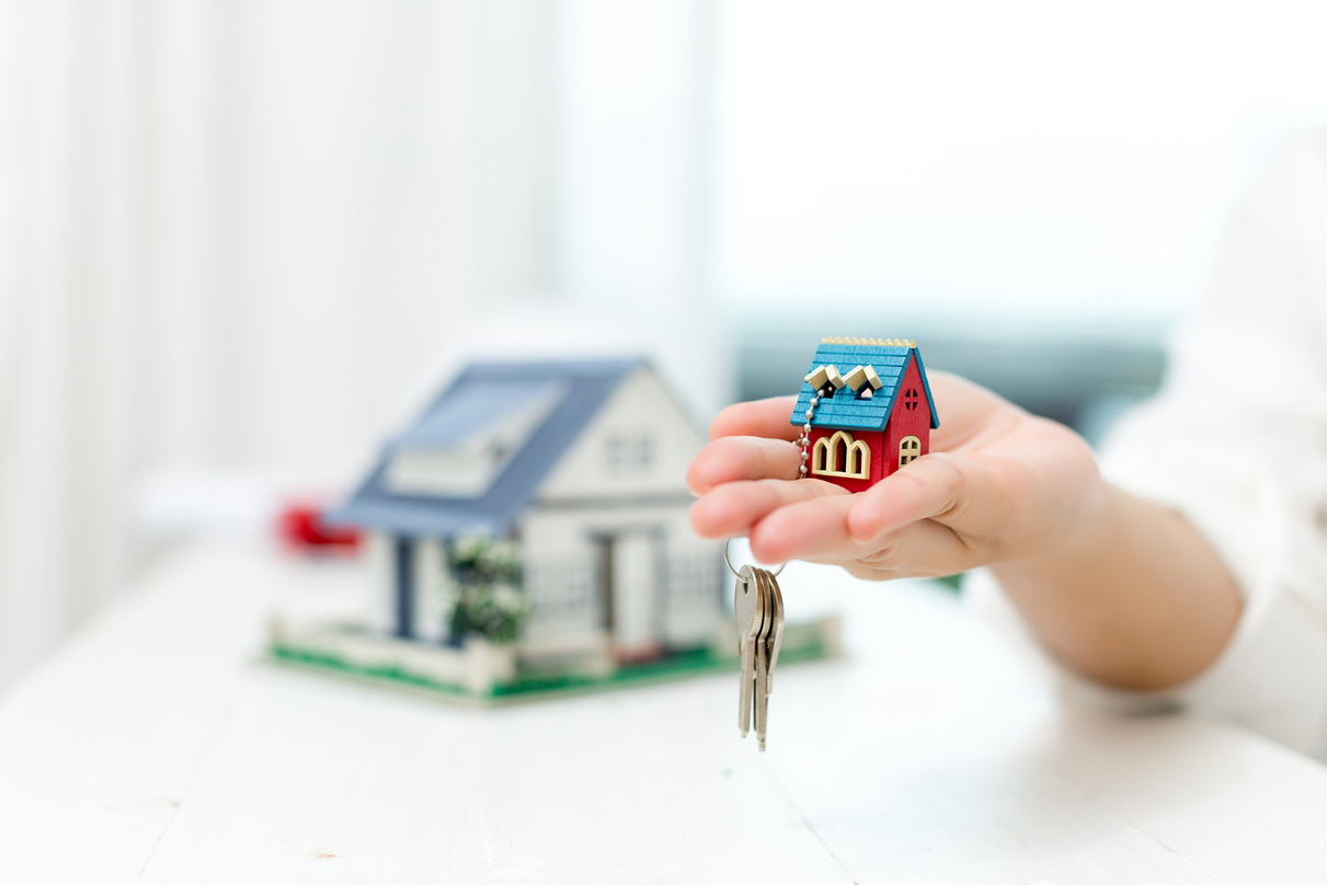 Real Estate Agent With House Model Keys